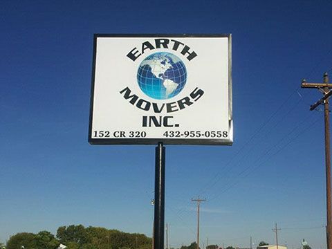 A sign for earth movers inc. against a blue sky