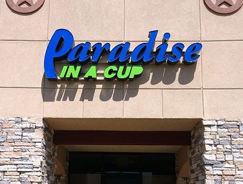 A sign for paradise in a cup on a building