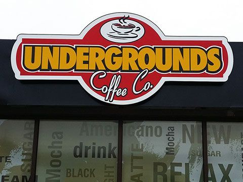 A sign for undergrounds coffee co. is above a window