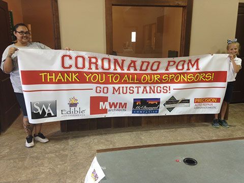 A woman and a girl are holding a banner that says coronado pom thank you to all our sponsors go mustangs.