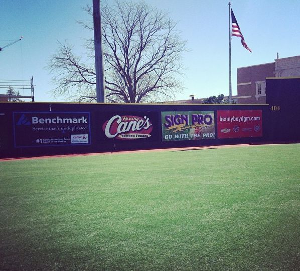 A baseball field with a sign that says benchmark on it