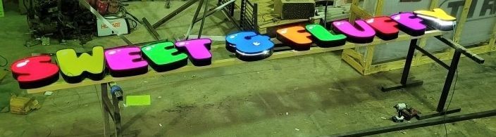 A colorful sign that says sweet & lucky is sitting on a table.