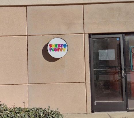 A sign on the side of a building that says sheeto fluffy