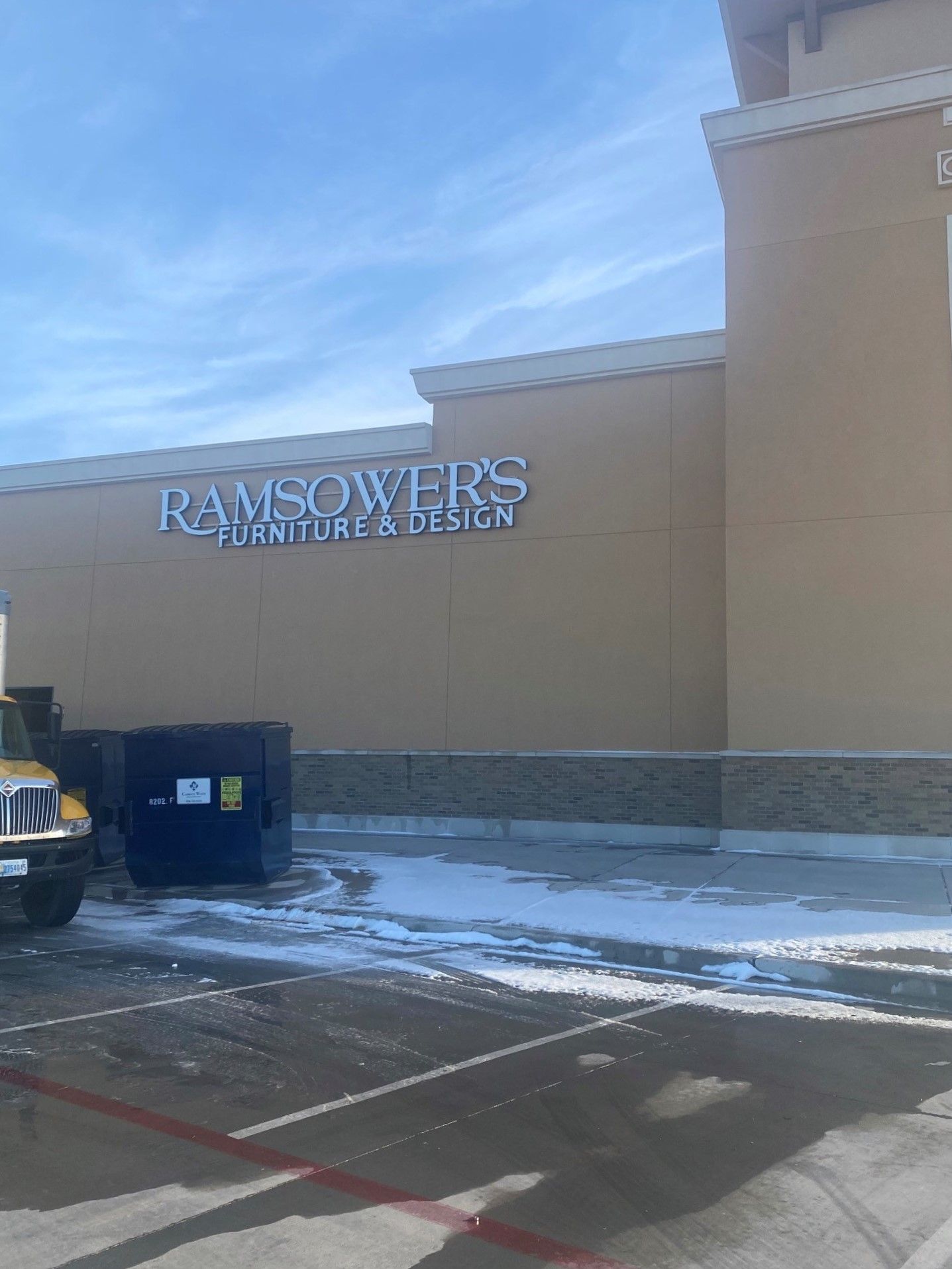 A truck is parked in front of a building that says ramsower 's