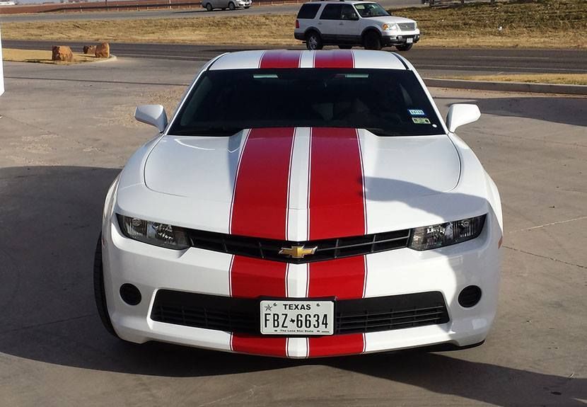 A white car with red stripes and a license plate that says fb2-6634