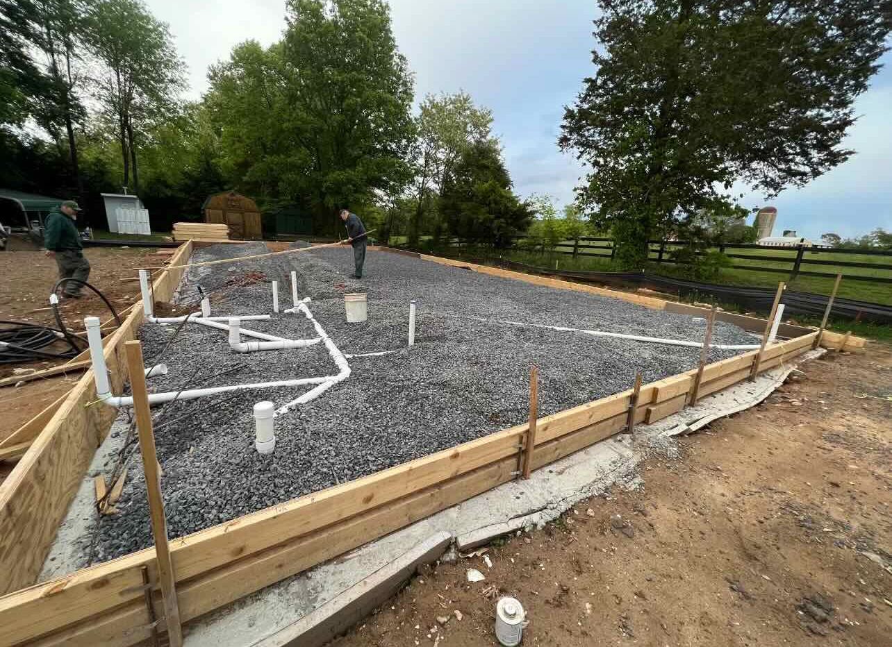 A man is standing in the middle of a construction site.