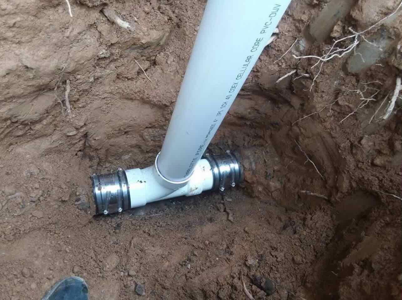 A pipe is being installed in a hole in the ground.