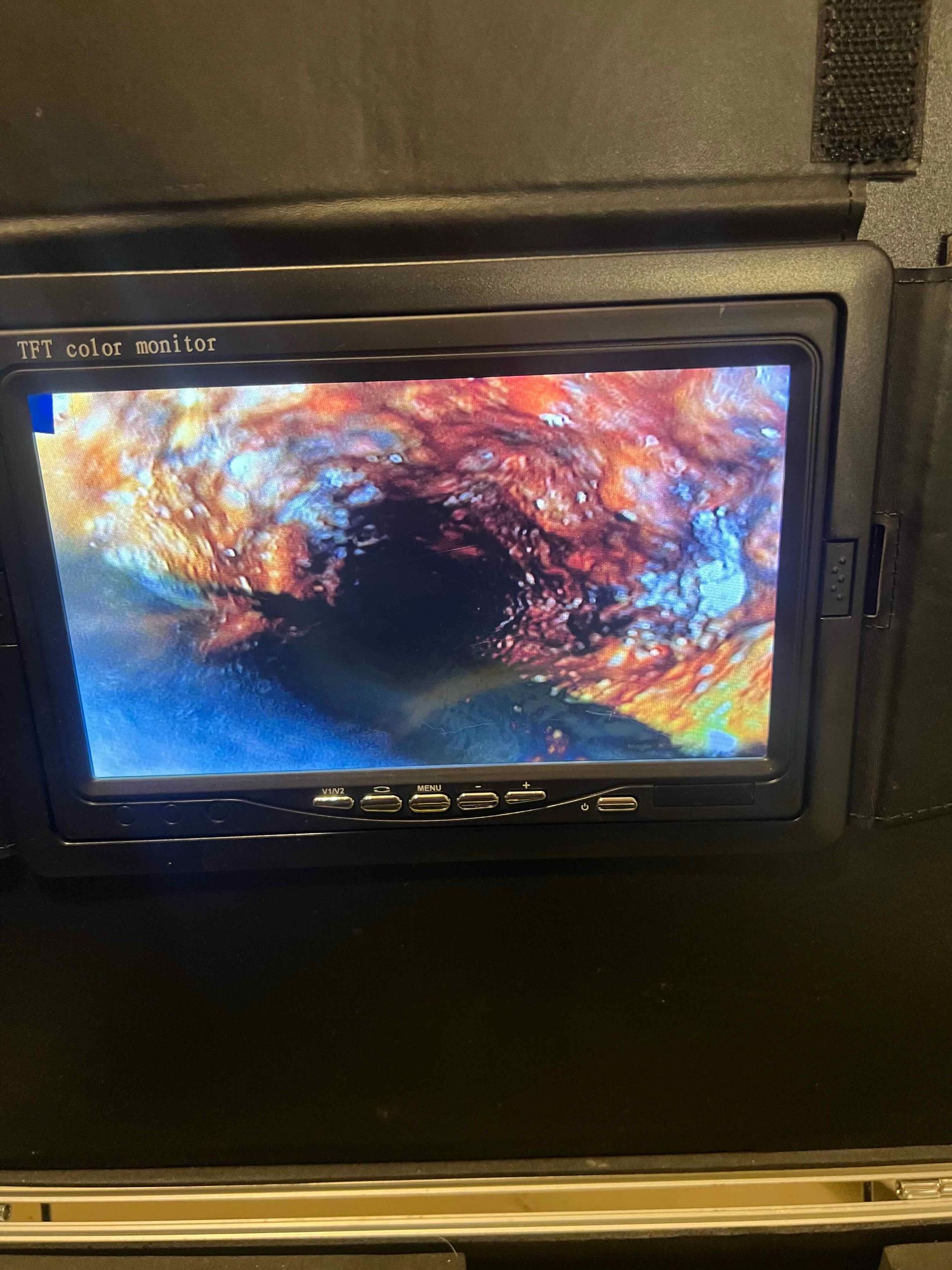 A monitor with a picture of a hole in the ground on it.