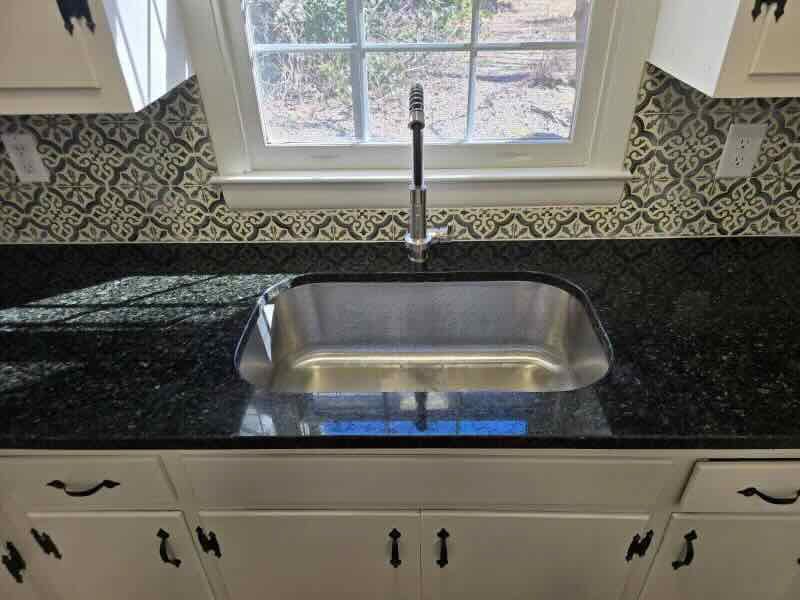 A kitchen sink with a window in the background