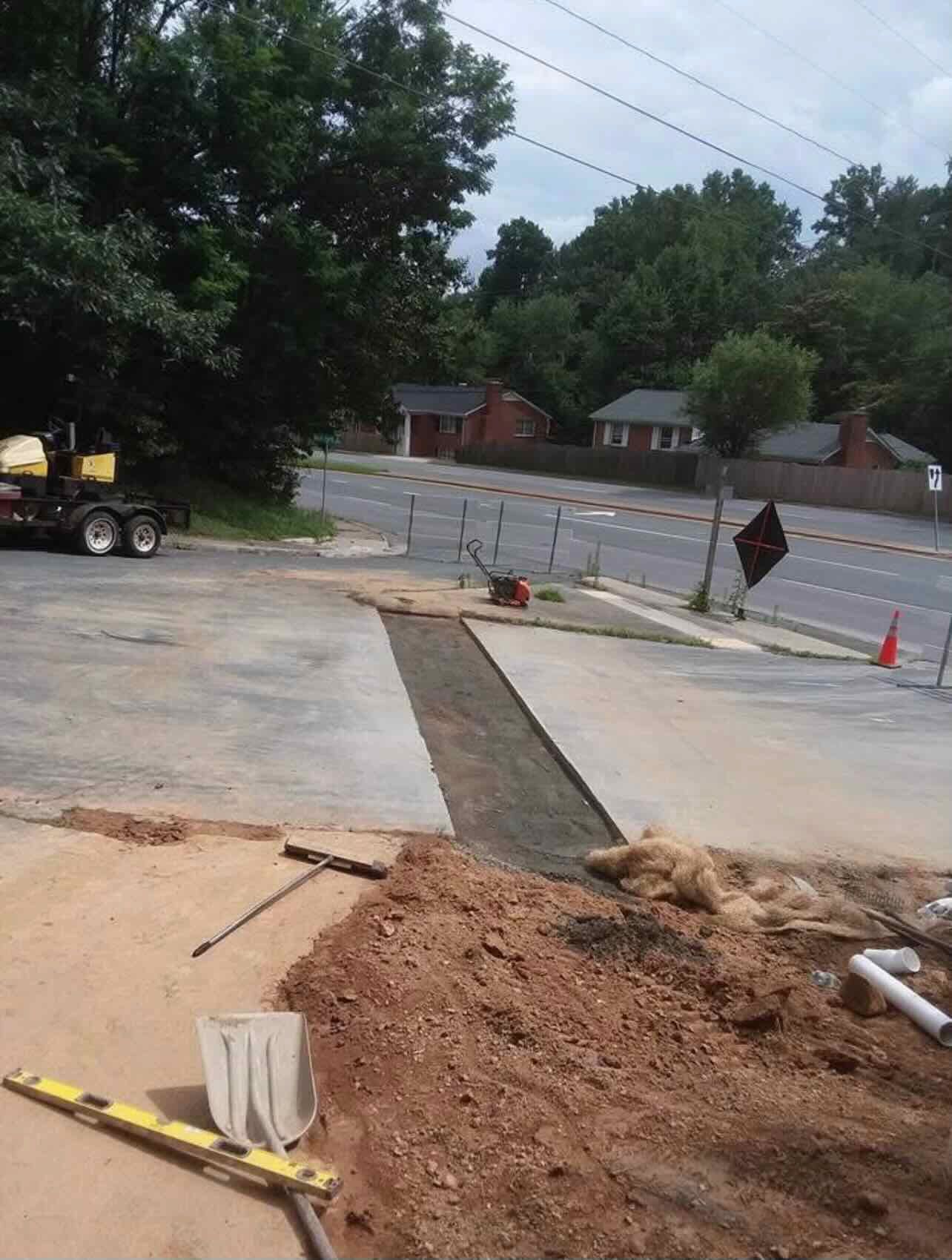 A concrete driveway is being built in a residential area