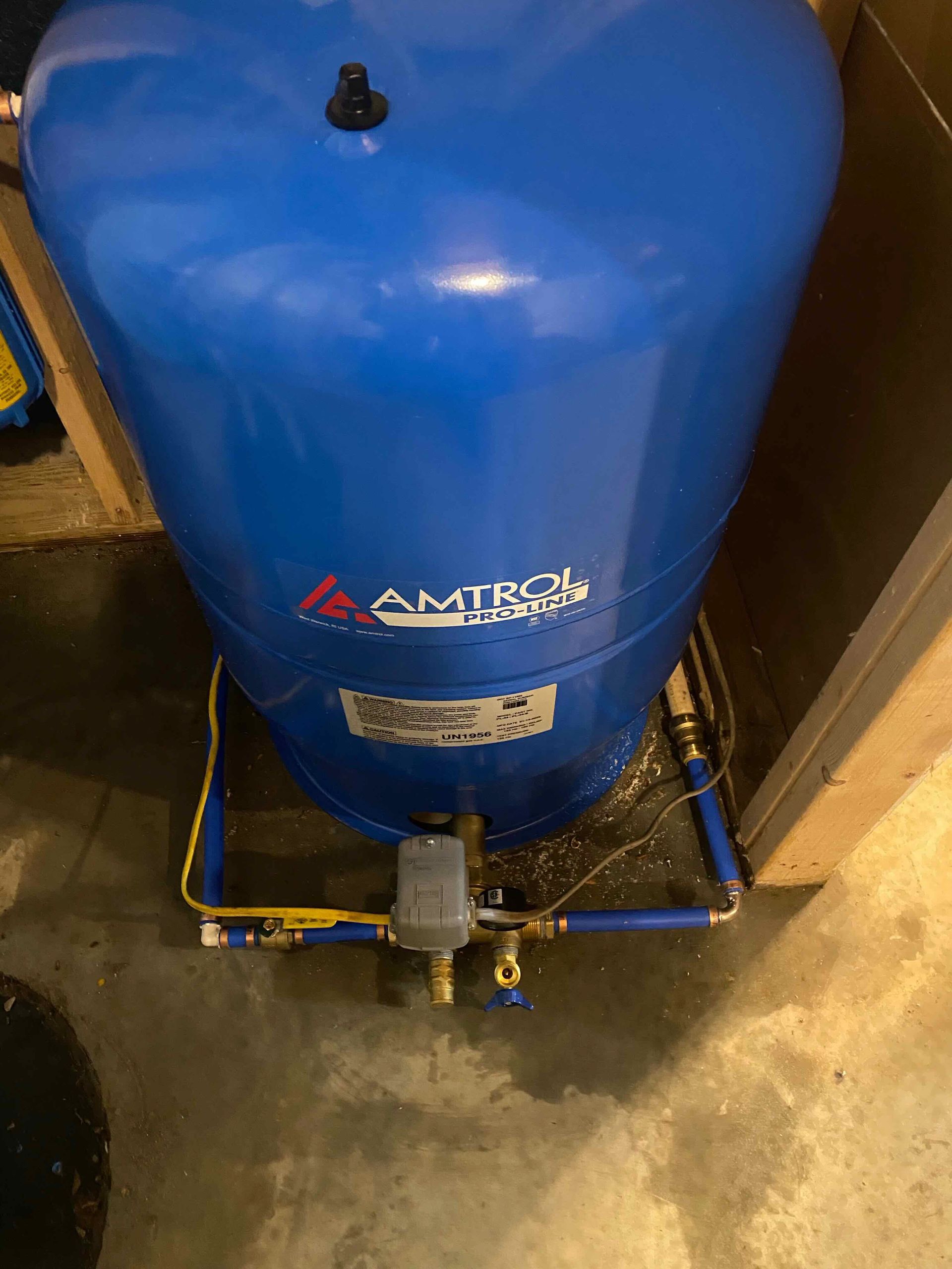 A blue water tank with the word amtrol on it