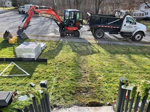 Front house with grass and trucks 