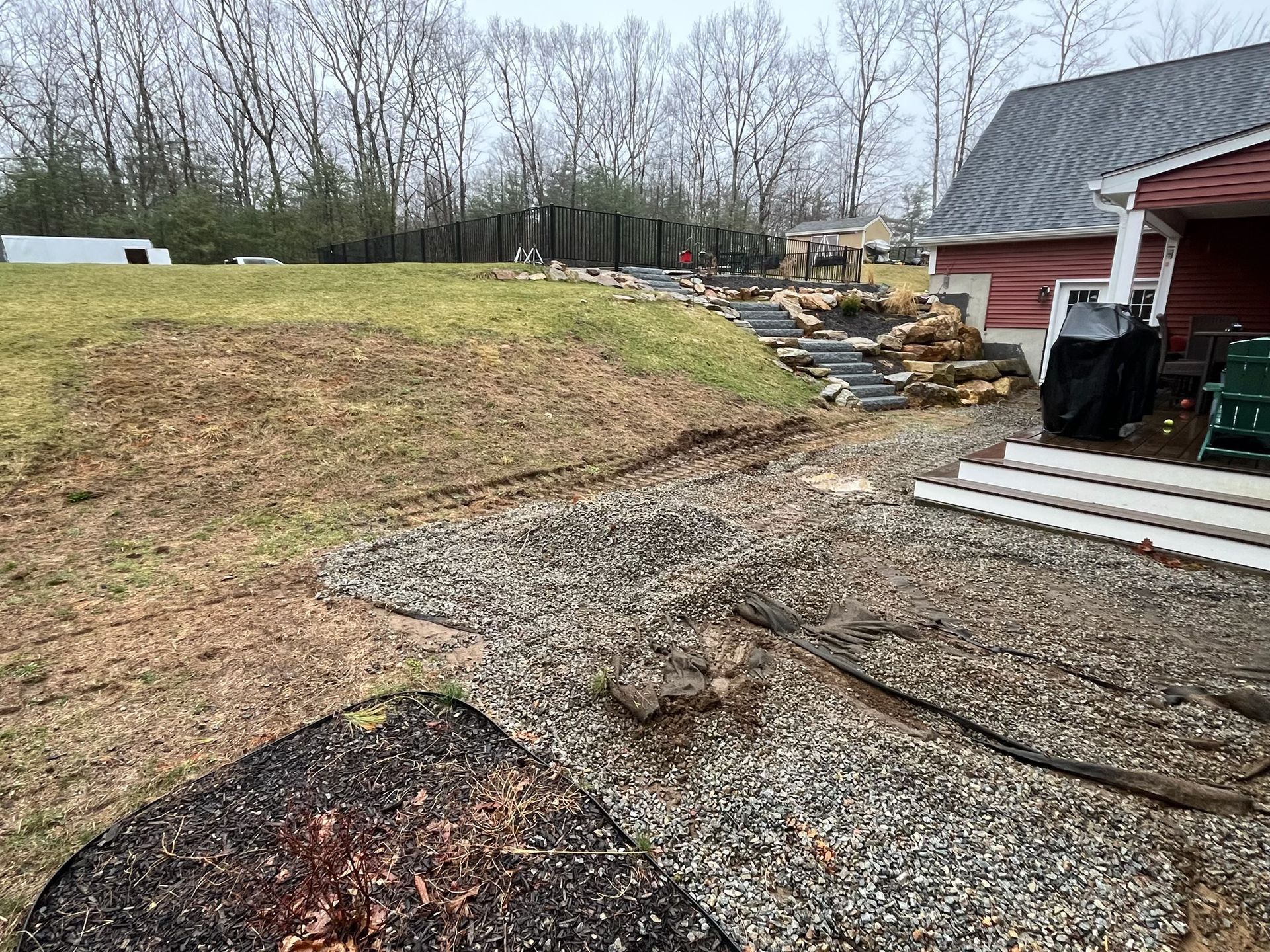 A house is being built on a hill next to a gravel path.