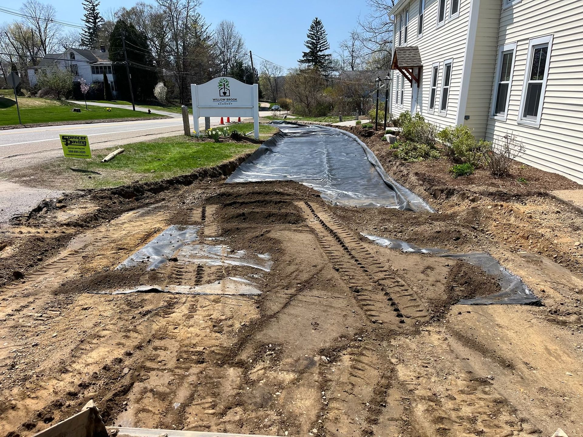 A dirt road is being built in front of a house.
