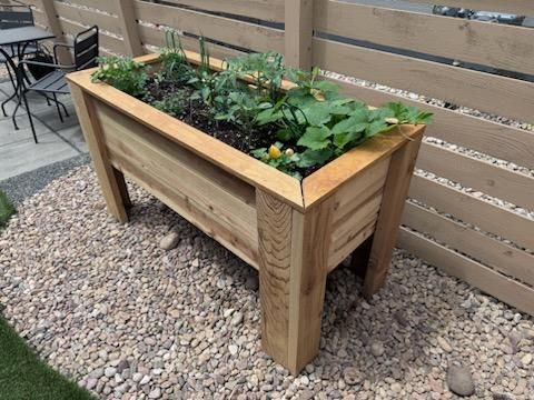 Artistic Escapes Multi-layered garden raised bed planter boxes, with legs and drainage creating a frame for the organic art created through plants EATON COLORADO landscape design landscape installation garden bed raised garden