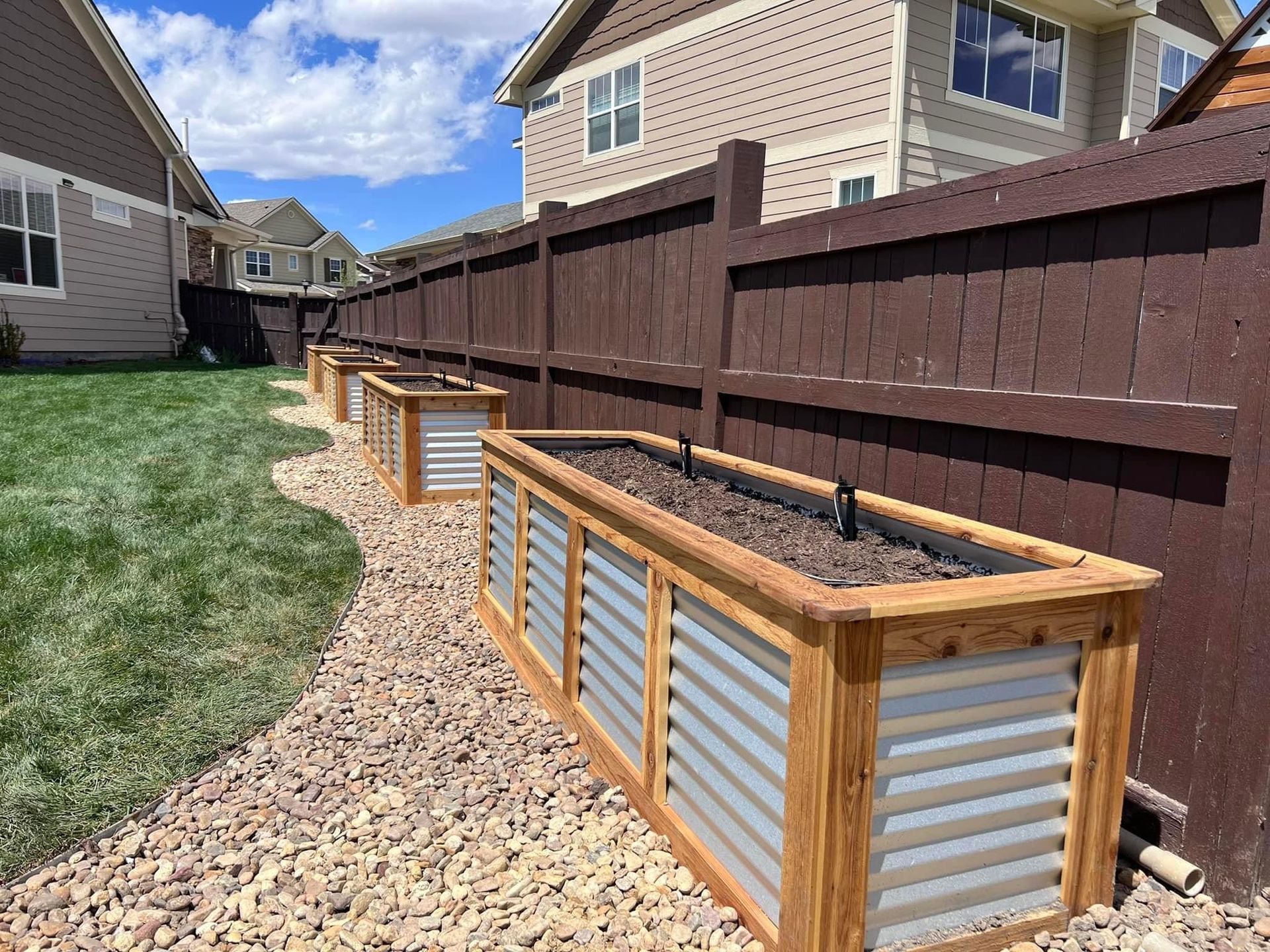 Artistic Escapes  corrugated metal and wood garden raised bed planter boxes, creating a frame for the organic art created through plants EATON COLORADO landscape design landscape installation garden bed raised garden