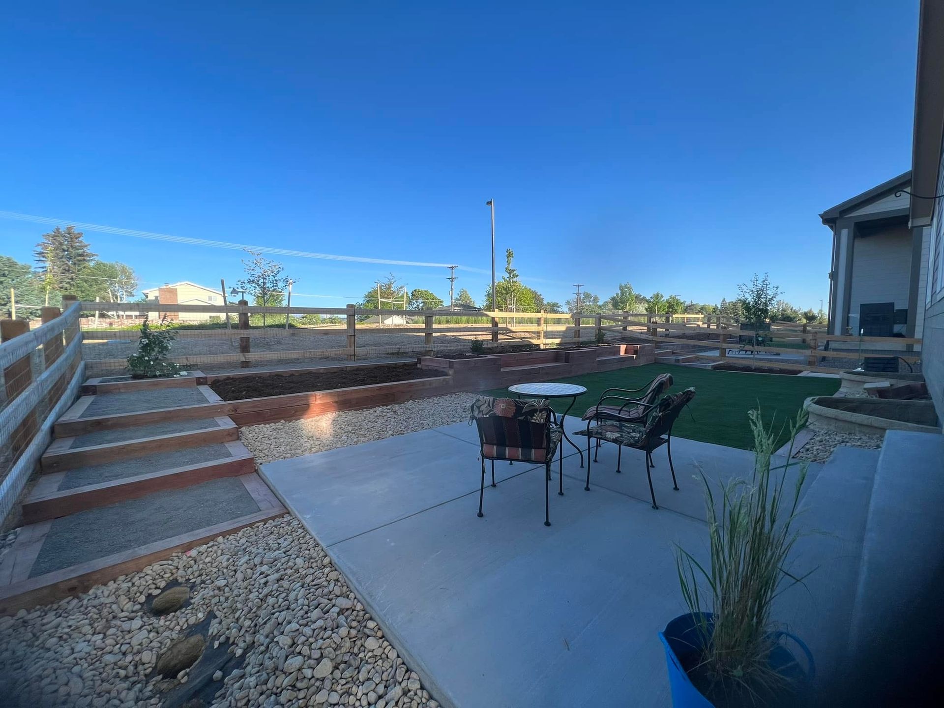 Artistic Escapes  stepped terraces of wood garden raised bed planter boxes, creating a frame for the organic art created through plants adding dimension in height adds character to this outdoor living space EATON COLORADO landscape design landscape installation garden bed raised garden