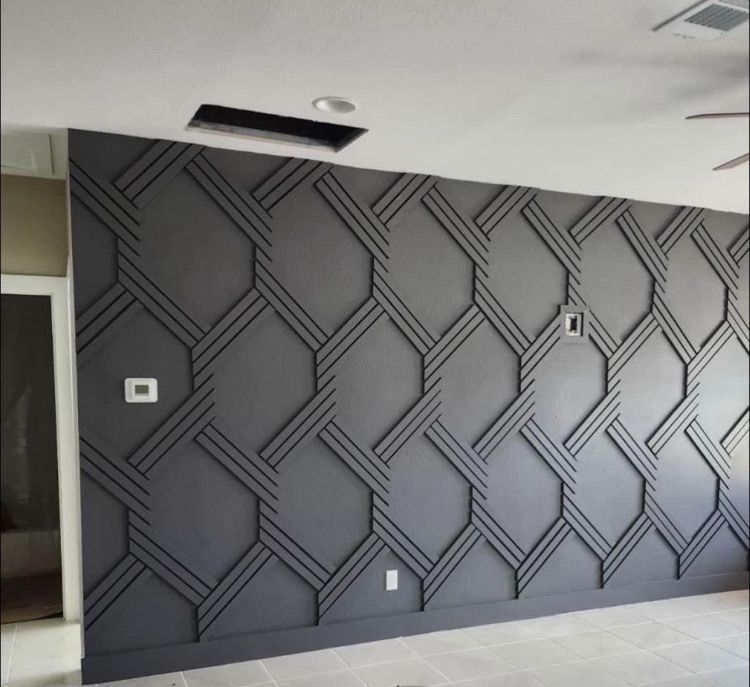 Gray geometric wall design with dark gray trim.