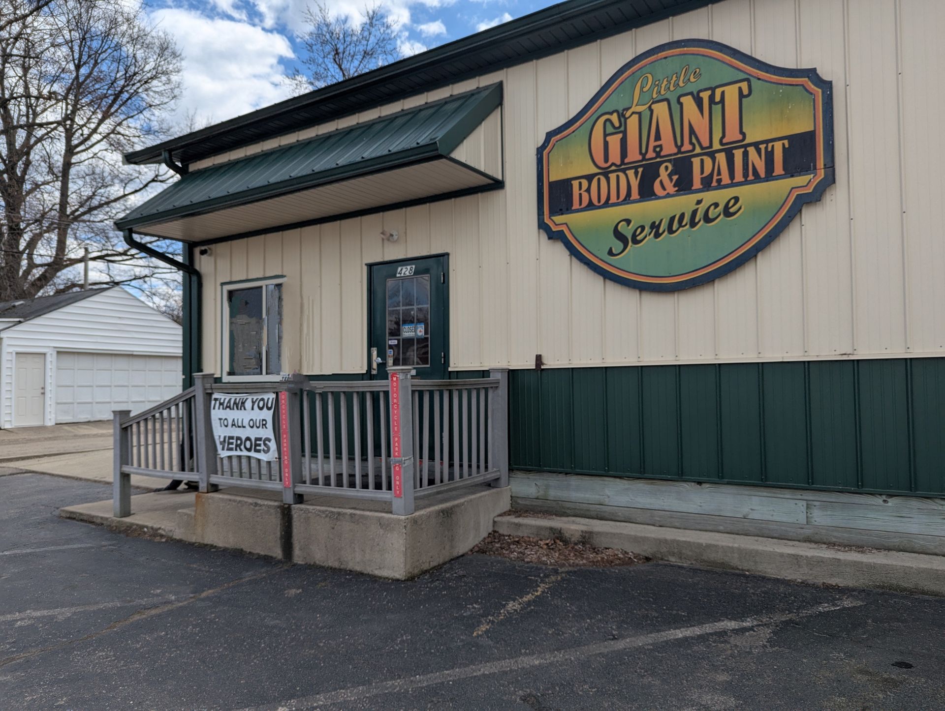 A building with a sign that says giant body and paint service