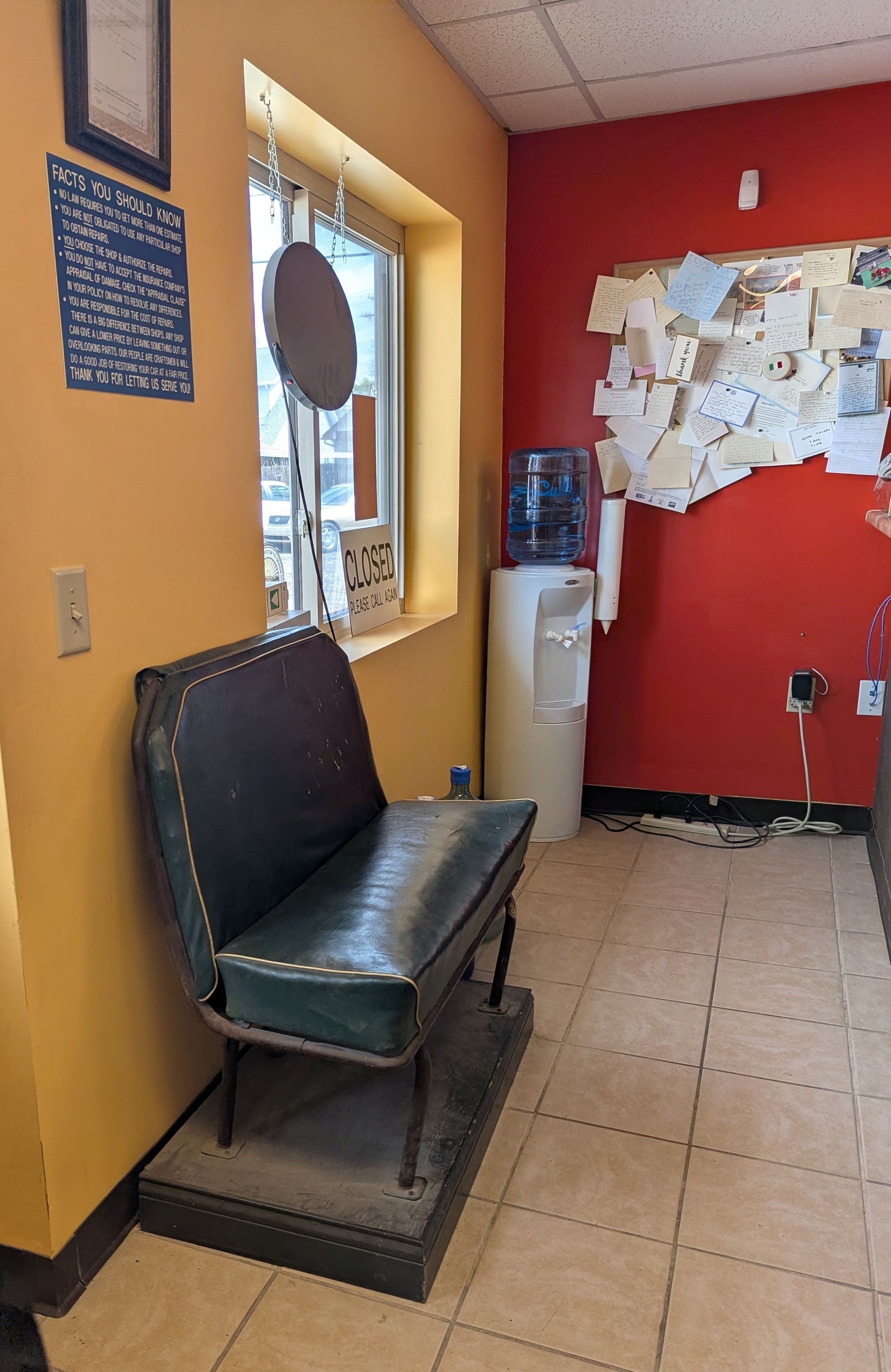 A little giant paint and body shop office with a red wall