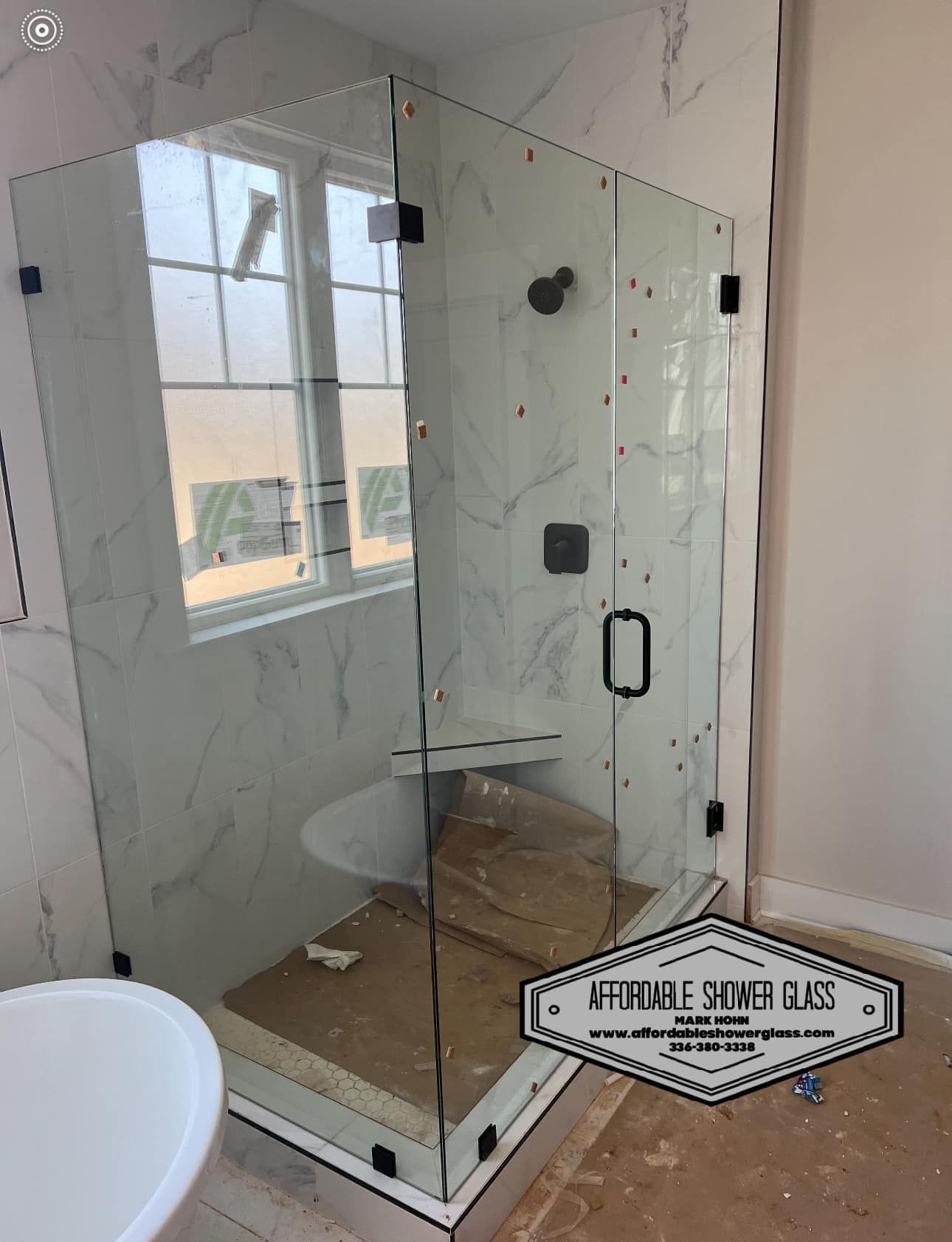 A bathroom with a shower stall and a toilet.