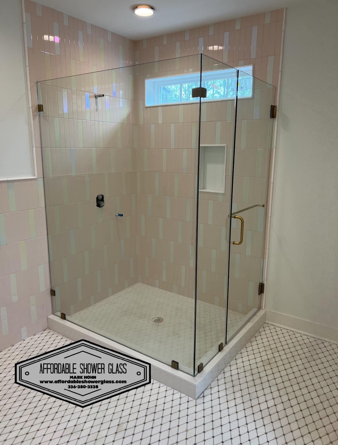 A bathroom with a walk in shower with a sliding glass door.