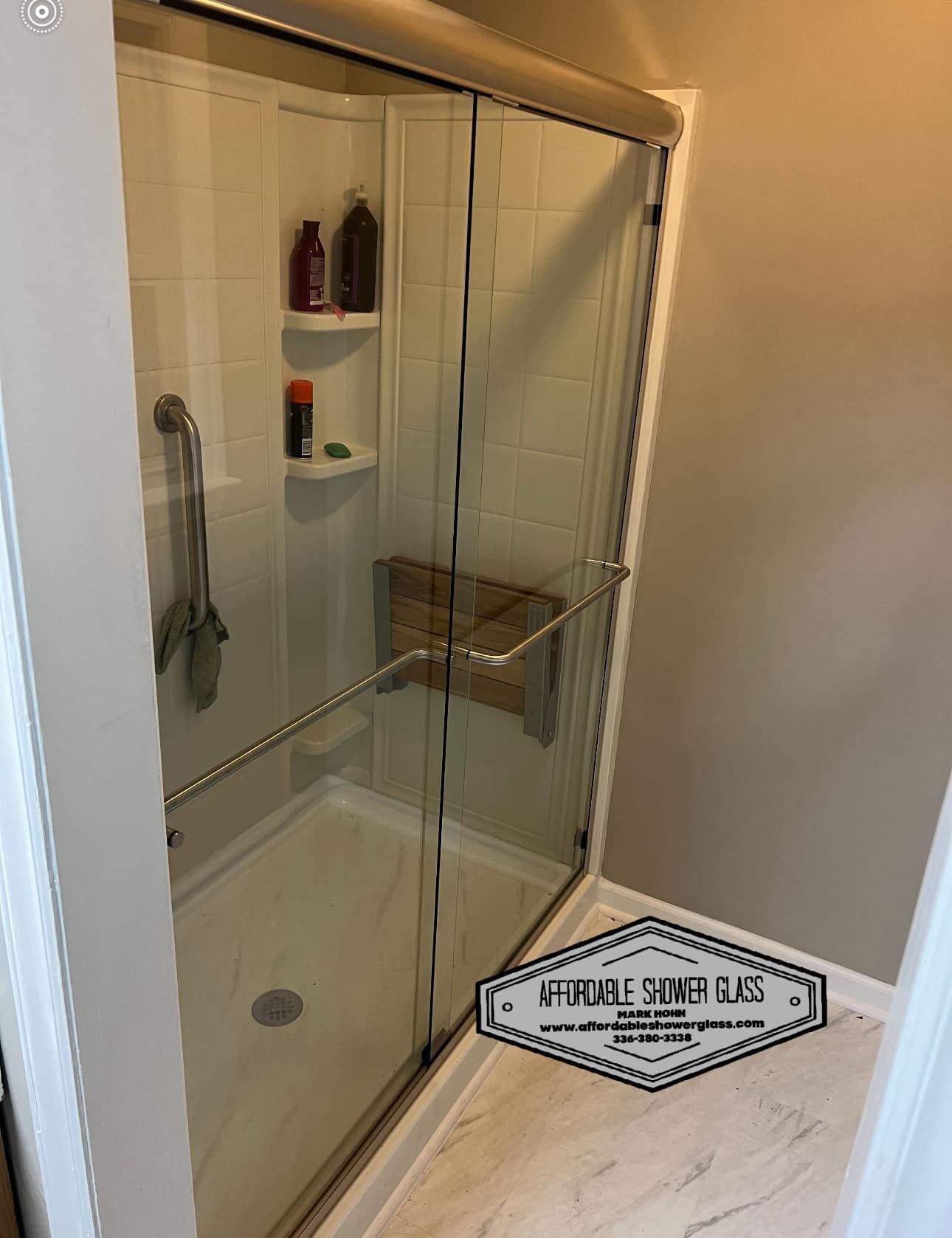 A bathroom with a sliding glass shower door.