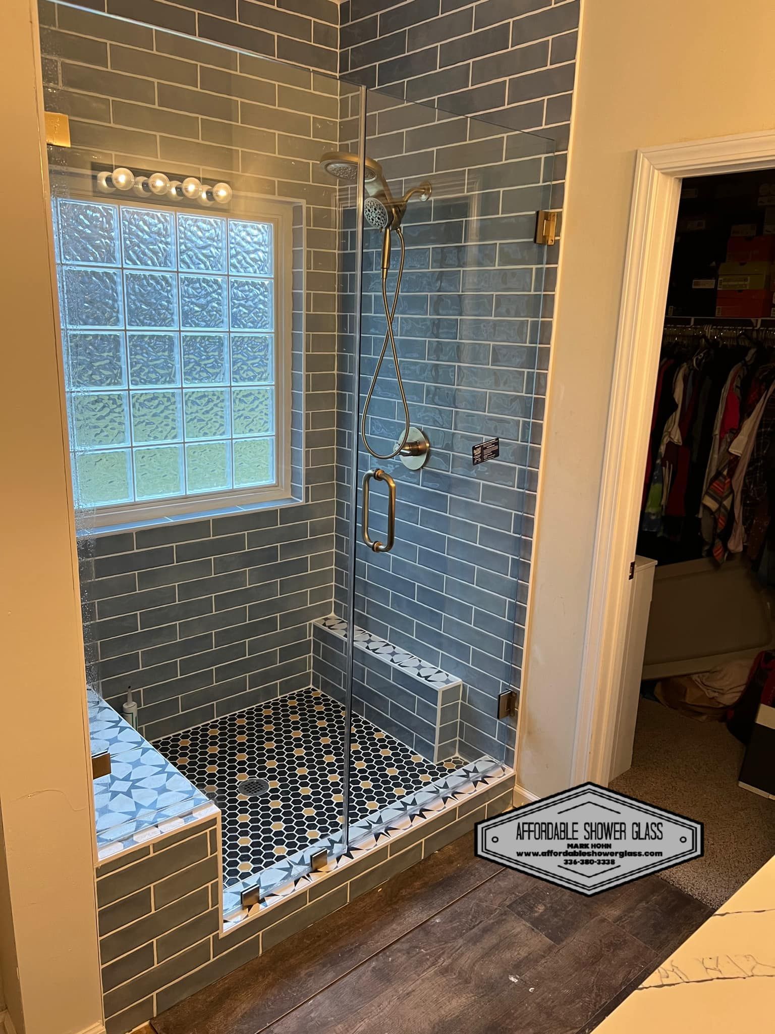 A bathroom with a walk in shower and a window.