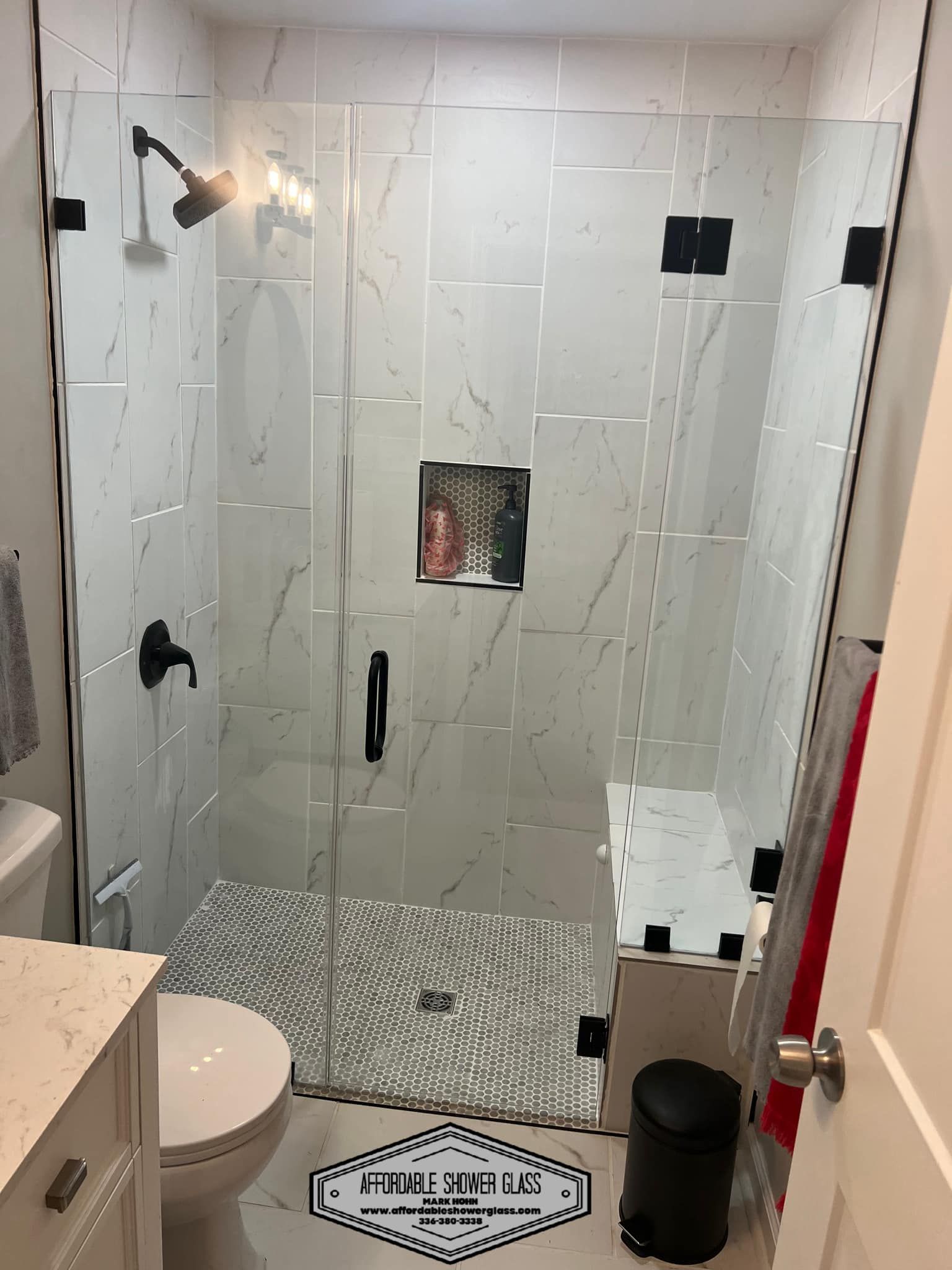 A bathroom with a walk in shower and a toilet.