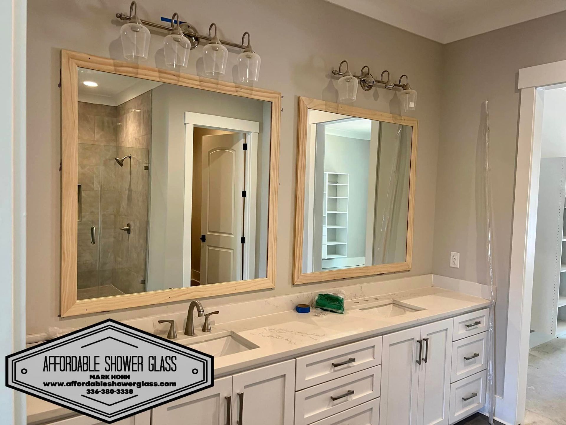 A bathroom with two sinks and two mirrors.