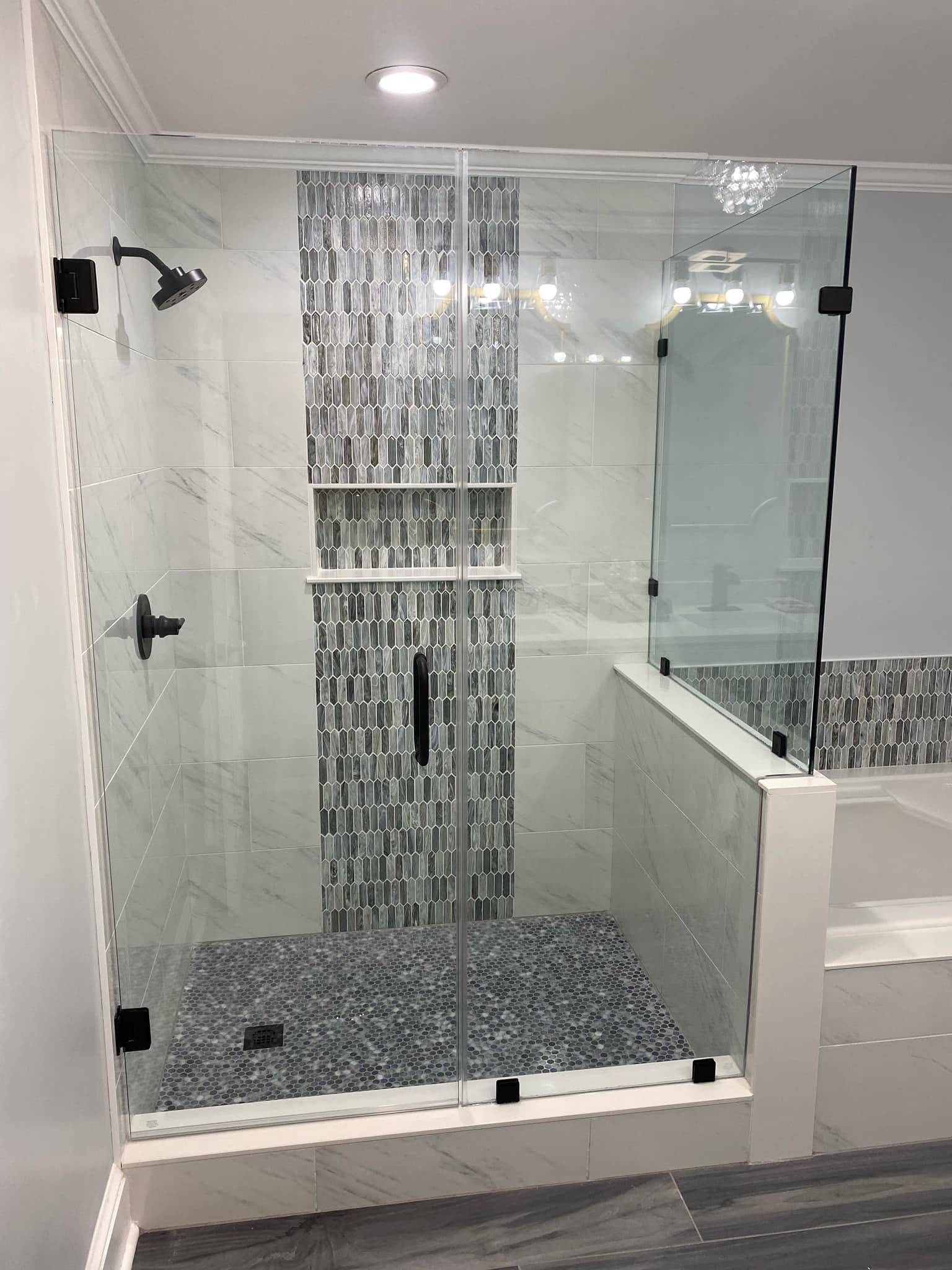 A bathroom with a walk in shower and a bathtub.