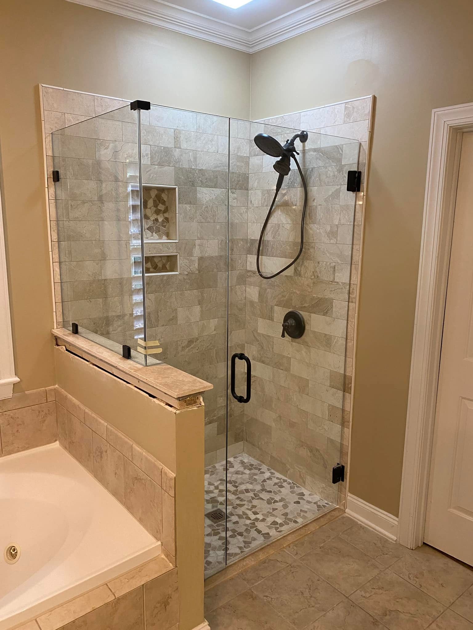 A bathroom with a walk in shower and a bathtub.