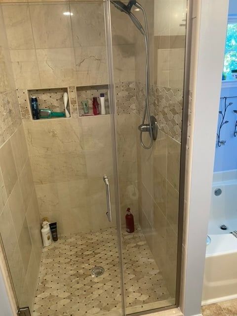 A bathroom with a walk in shower and a bathtub.