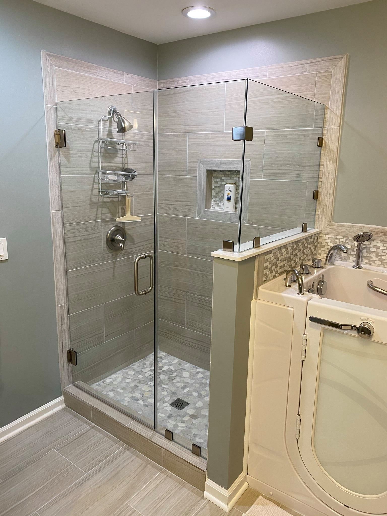 A bathroom with a walk in shower and a bathtub.