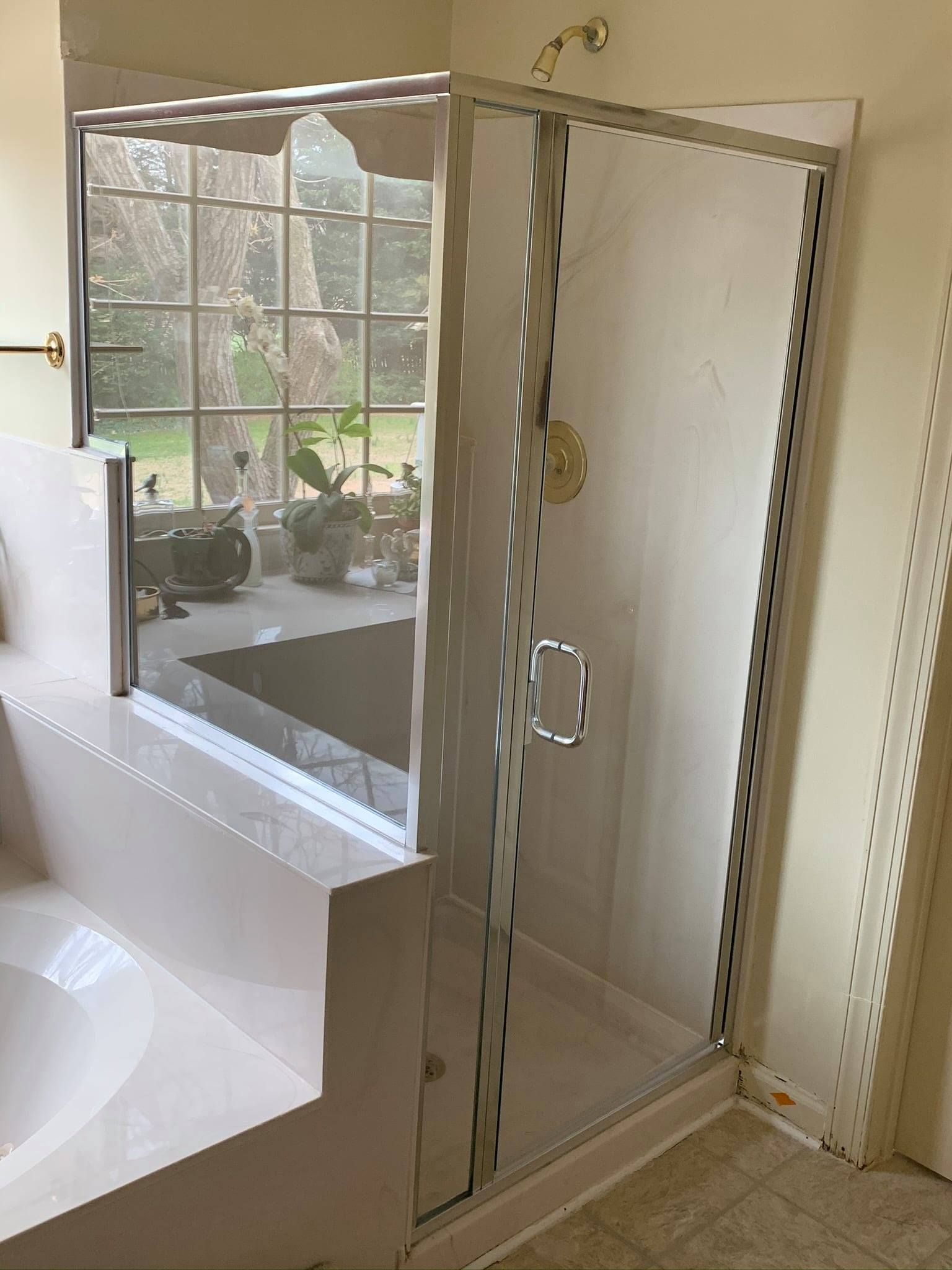 A bathroom with a walk in shower and a bathtub.