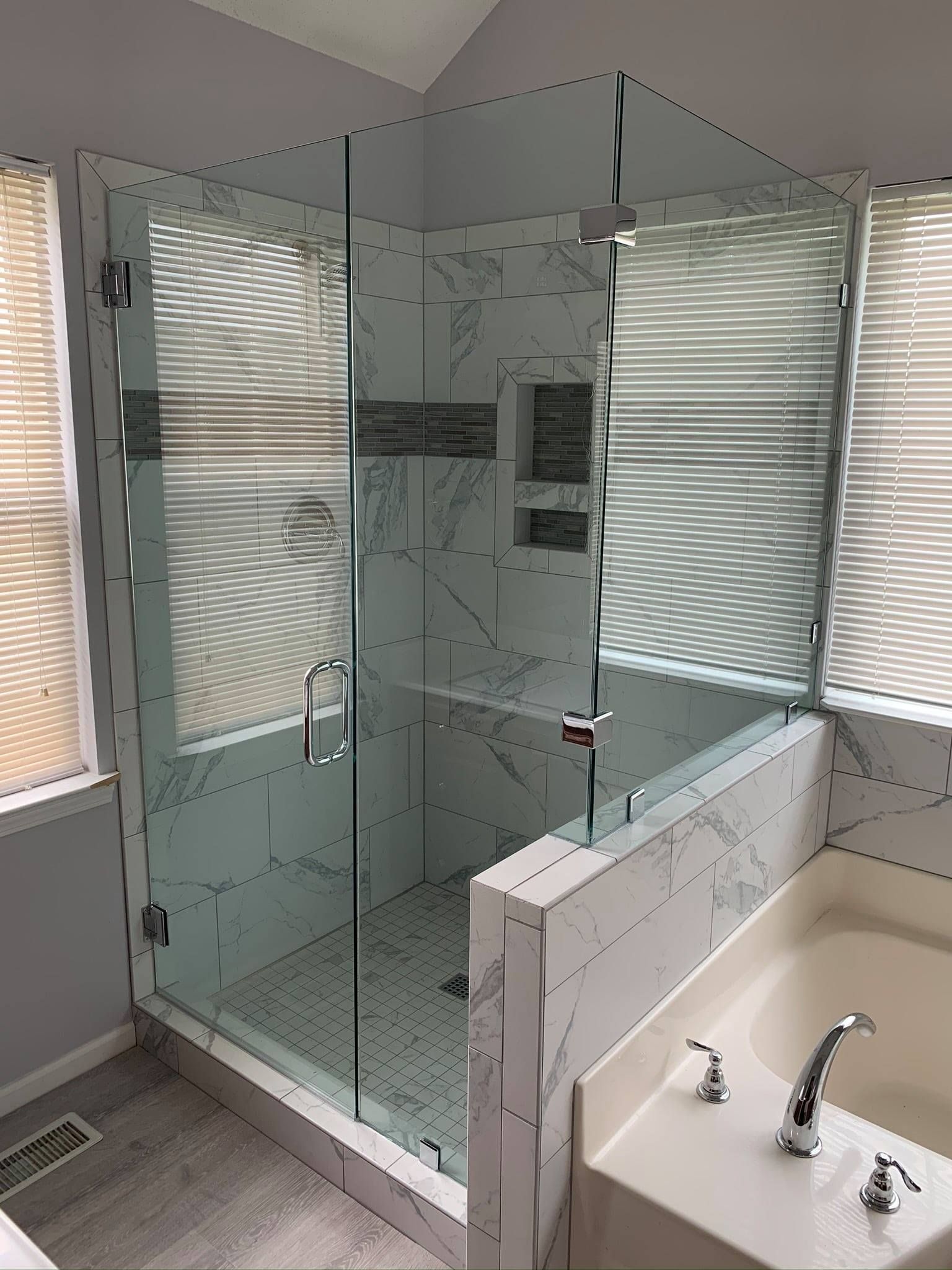 A bathroom with a walk in shower and a bathtub.
