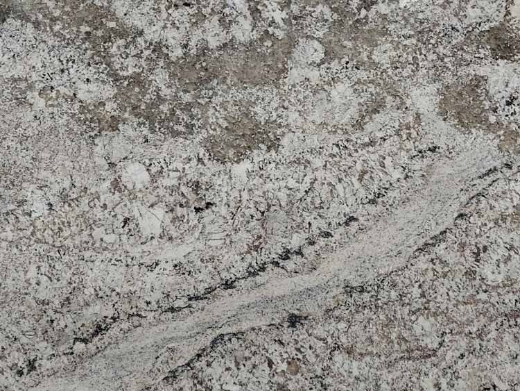 Close-up of granite countertop with white, gray, and black speckles and veins.