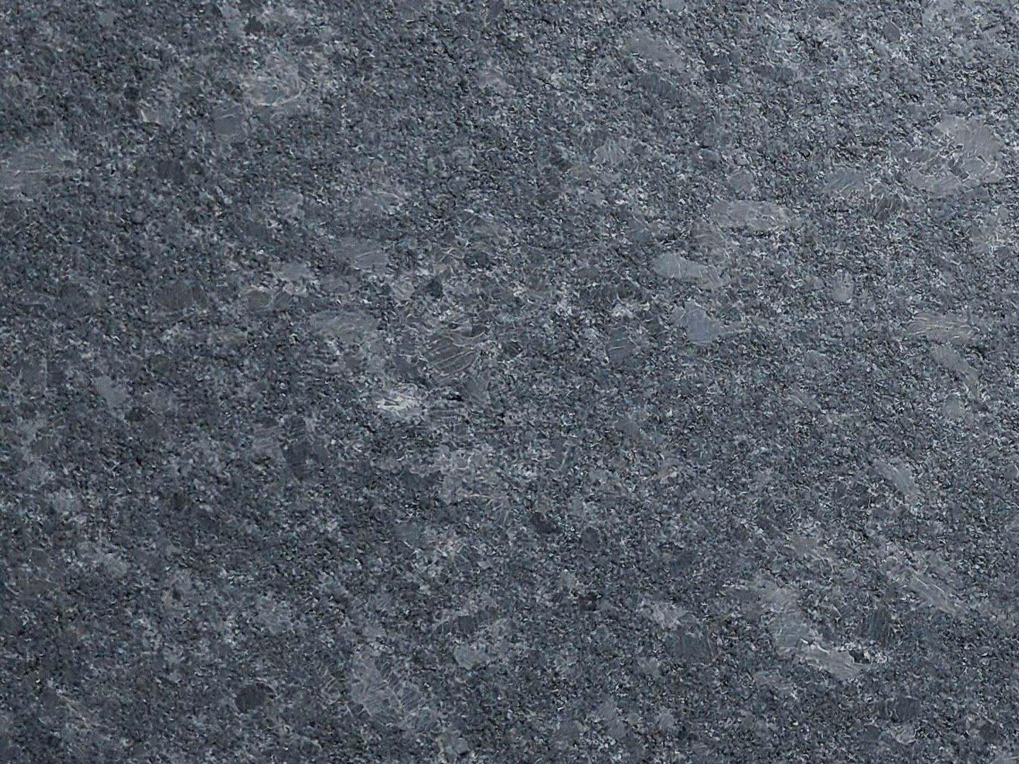 Dark gray speckled stone surface.