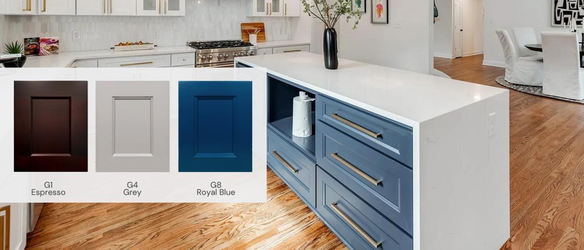 A kitchen island with blue cabinets, a white countertop, and samples of cabinet colors.