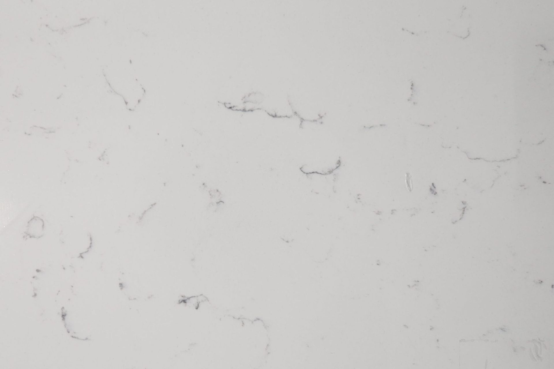 White countertop with subtle gray veining.