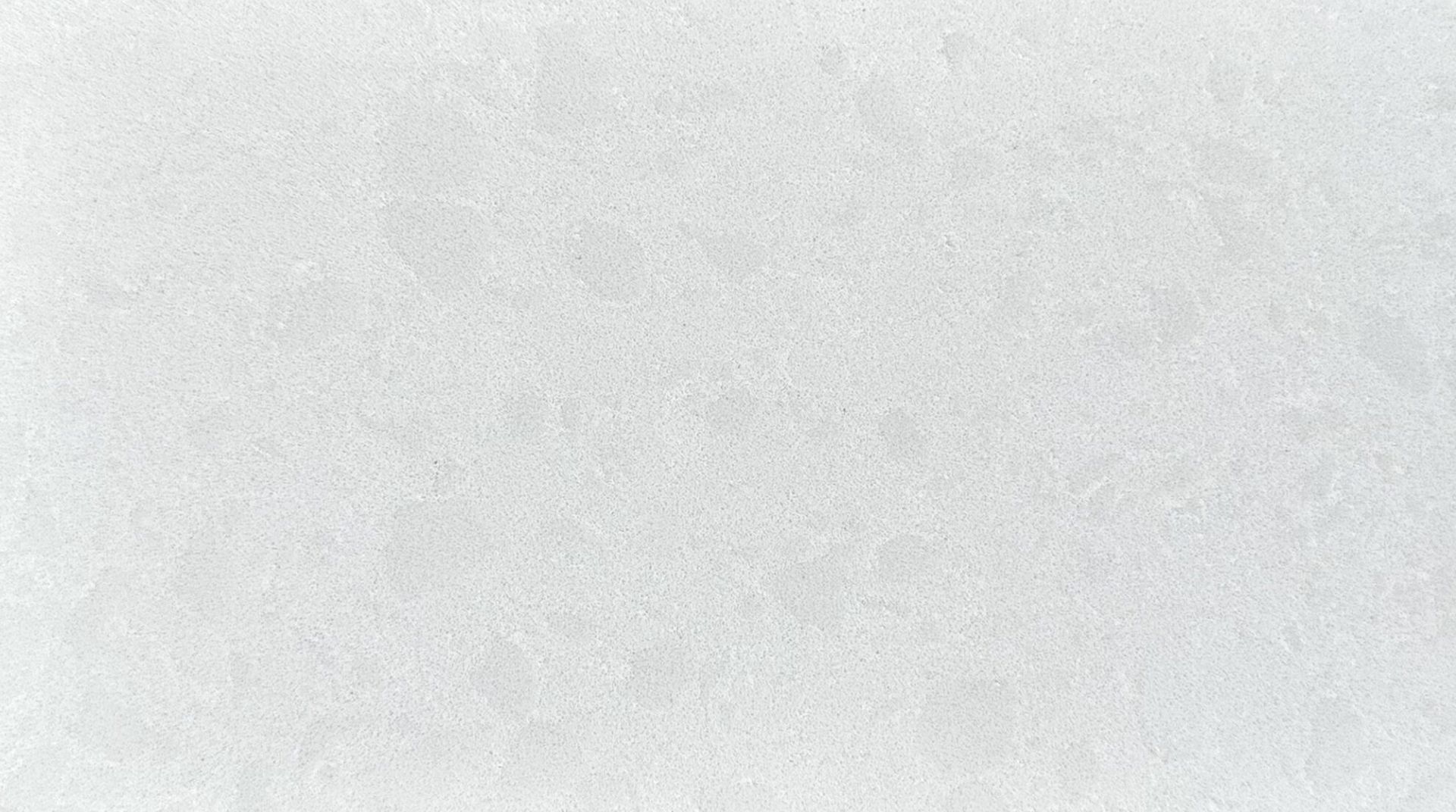 White, textured surface with subtle variations in tone.