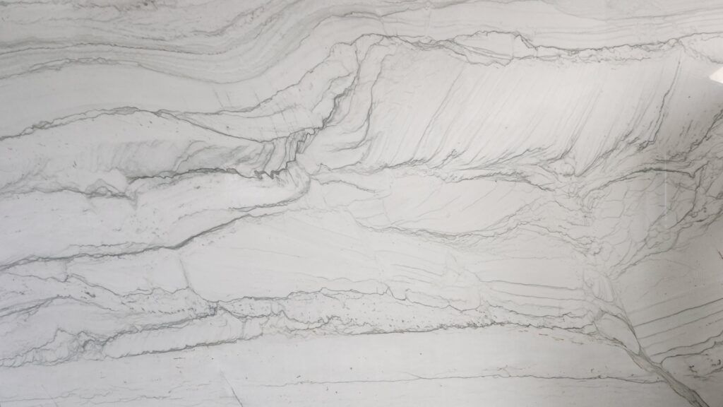 White countertop with gray veining resembling flowing water.