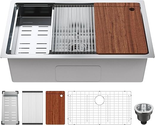 Stainless steel kitchen sink with accessories: drying rack, cutting board, and bottom grid.
