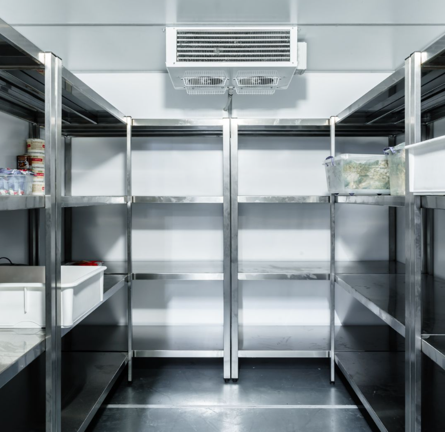 Stainless steel shelves inside a walk-in cooler; food storage.
