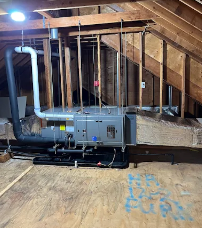 HVAC unit in an attic; wooden beams, ductwork, and wiring are visible.