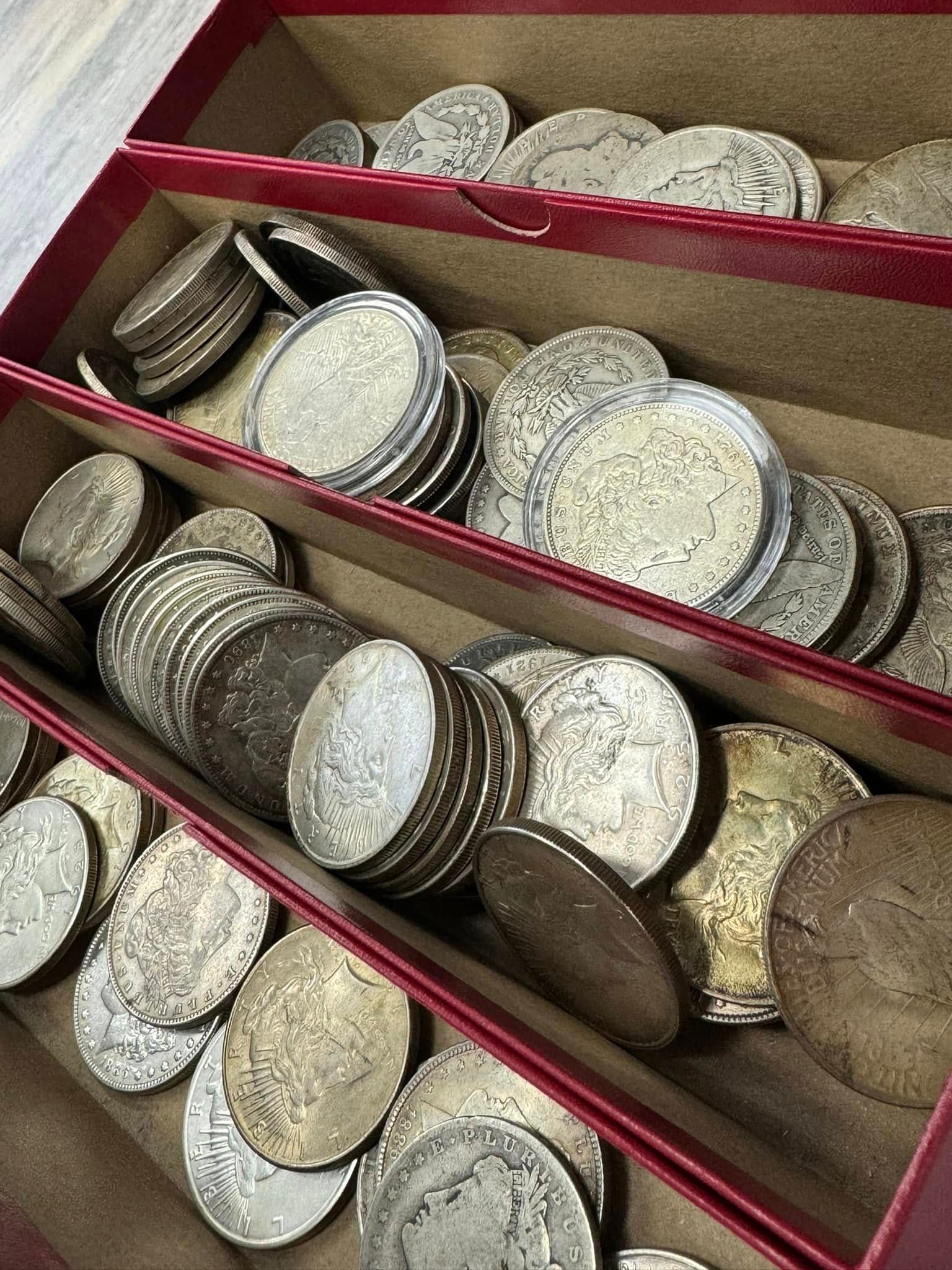 Rows of metal coin stacks in red tray compartments, seen from above