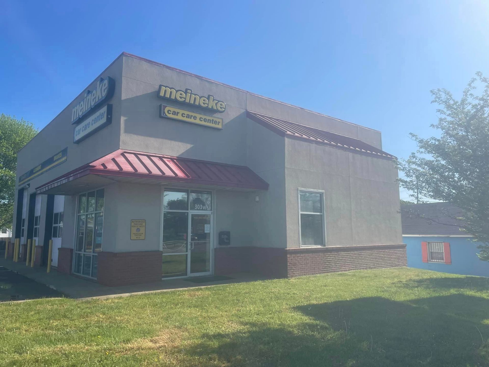 Exterior of a McDonald’s restaurant with a red awning on a sunny day