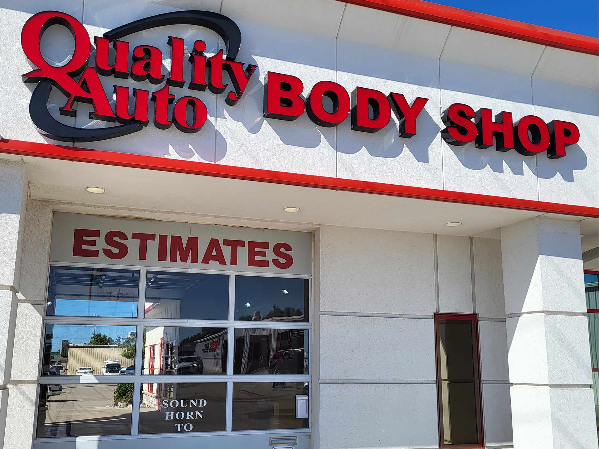 A quality auto body shop with estimates on the window