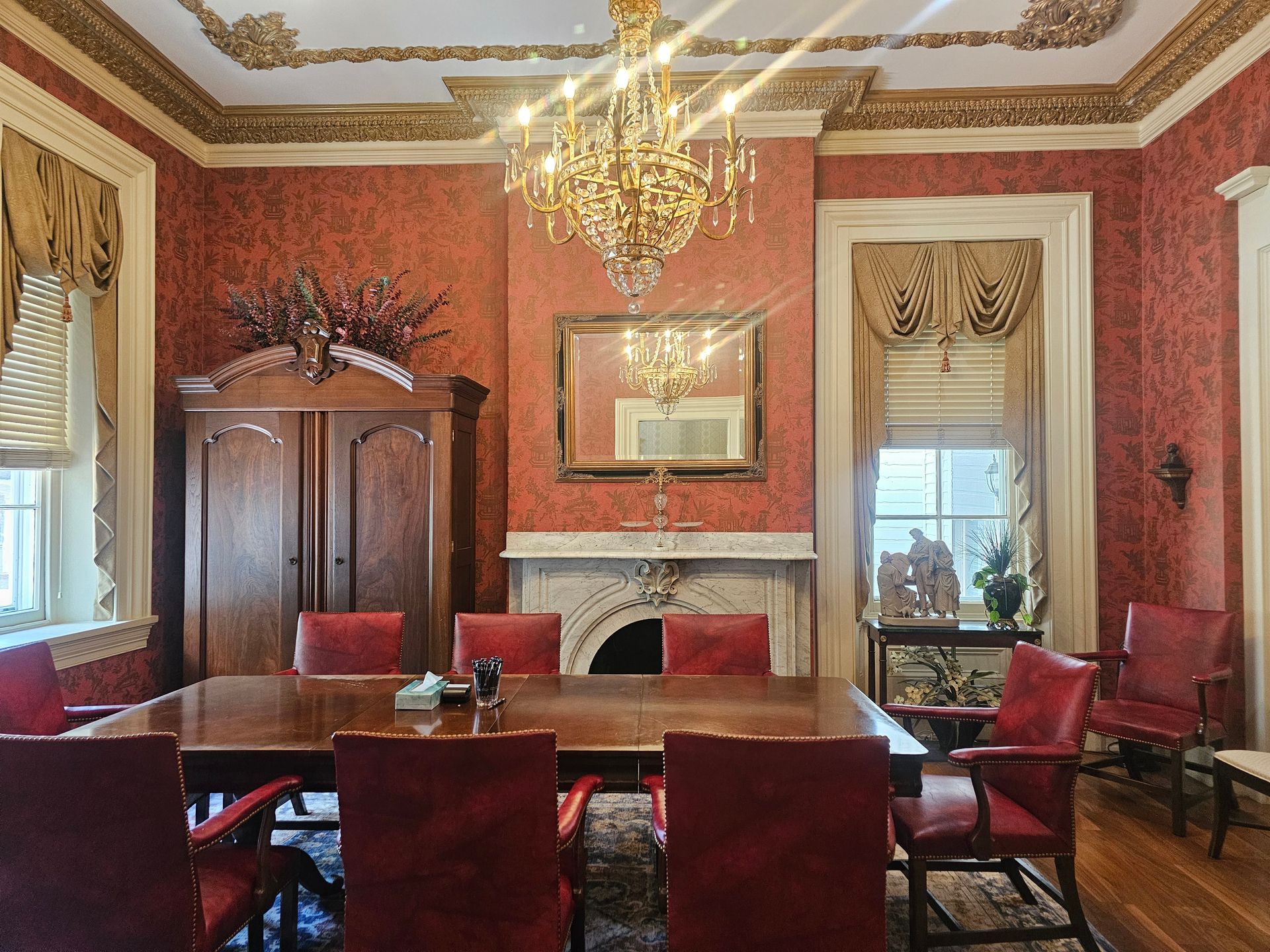 A judge is holding a pen and pointing at a piece of paper.