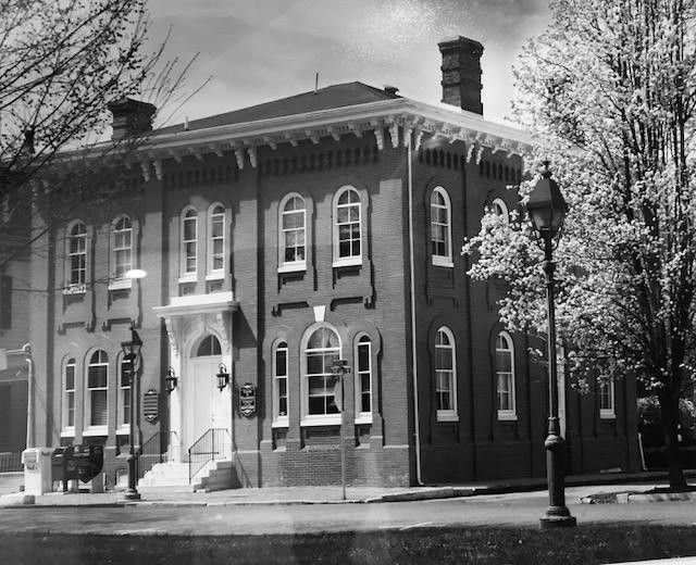 A black and white photo of a large brick building